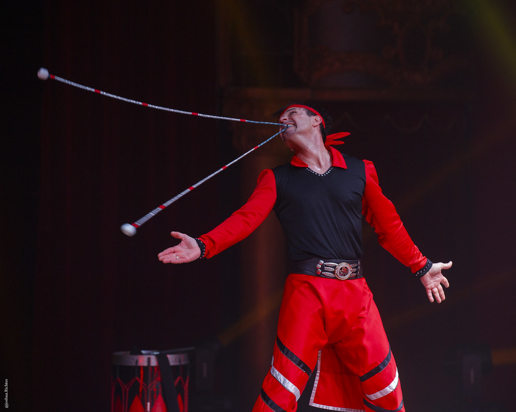 Milton performing a high-precision gaucho act holding a boleadora in his mouth.